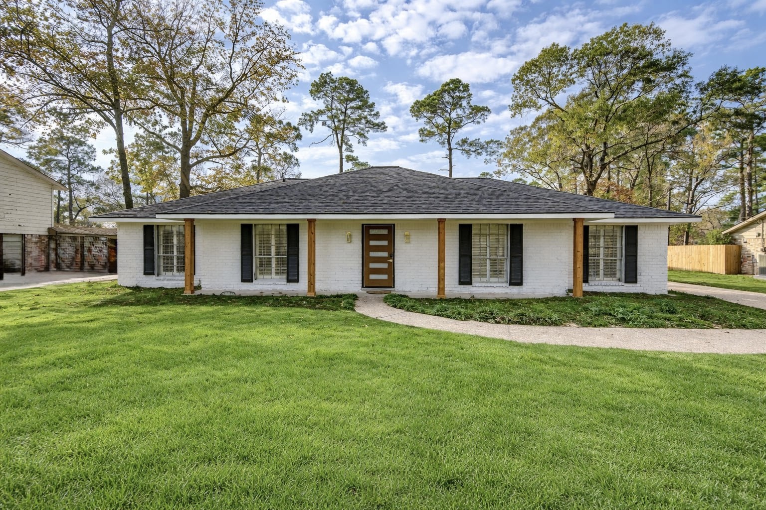 25607 Spring Ridge Drive Spring, TX 77386 - Photo 3 of 50 Fully renovated single-story home with white brick exterior, modern entry, spacious lot, long driveway, with detached garage