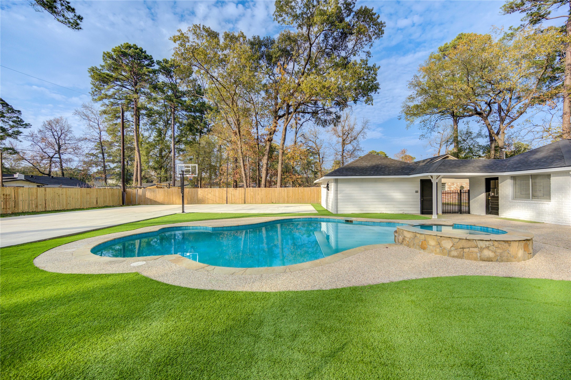 25607 Spring Ridge Drive Spring, TX 77386 - Photo 40 of 50 Resort-style backyard with heated pool, spa, clean turf, and mini-golf area