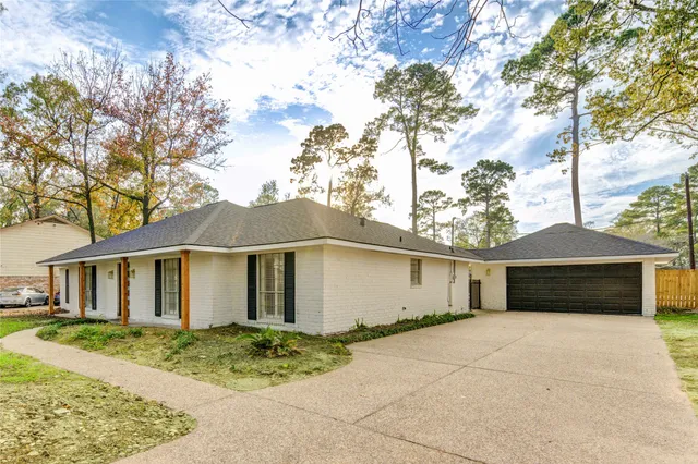 a view of empty room with wooden floor and window