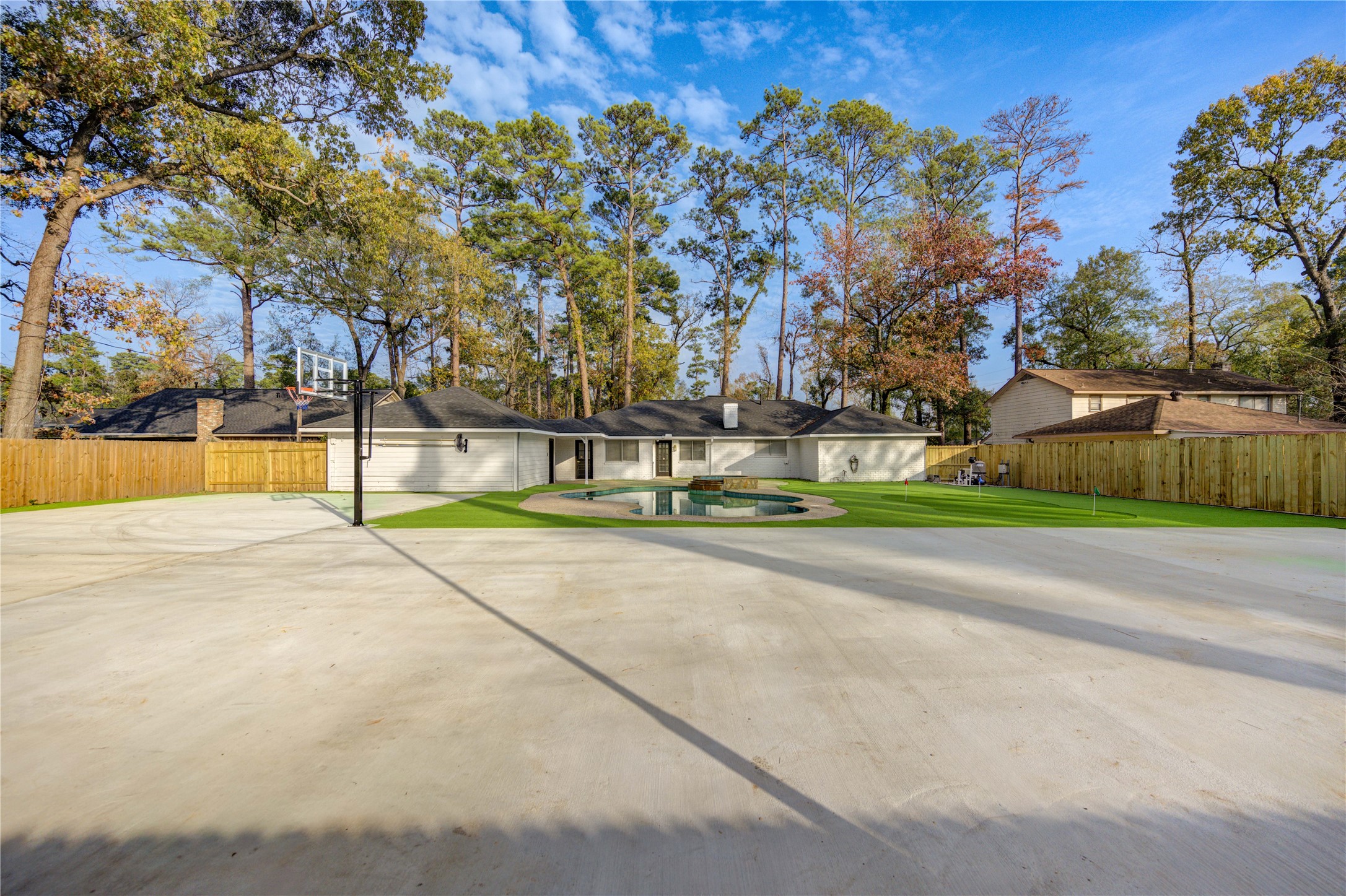 25607 Spring Ridge Drive Spring, TX 77386 - Photo 46 of 50 Expansive 3600 sf concrete ready for private sport courts with basketball hoop and two 16ft light poles, fully surrounded by artificial turf. Low maintenance and No space is wasted.
