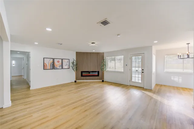 a kitchen with stainless steel appliances granite countertop a sink a stove and a wooden floors