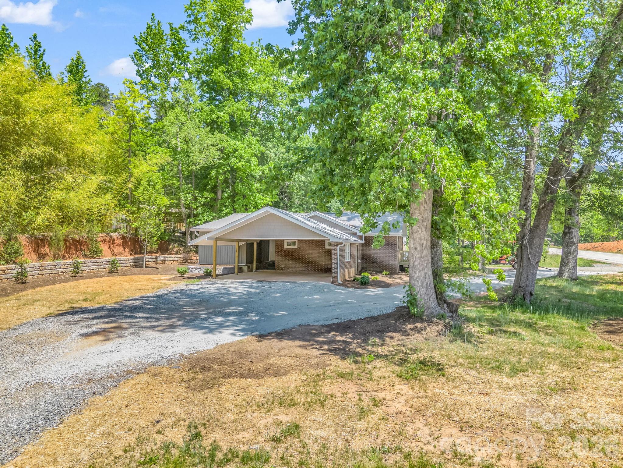 5923 Highway 14 Landrum, SC 29356 - Photo 2 of 15 a view of a house with backyard and trees