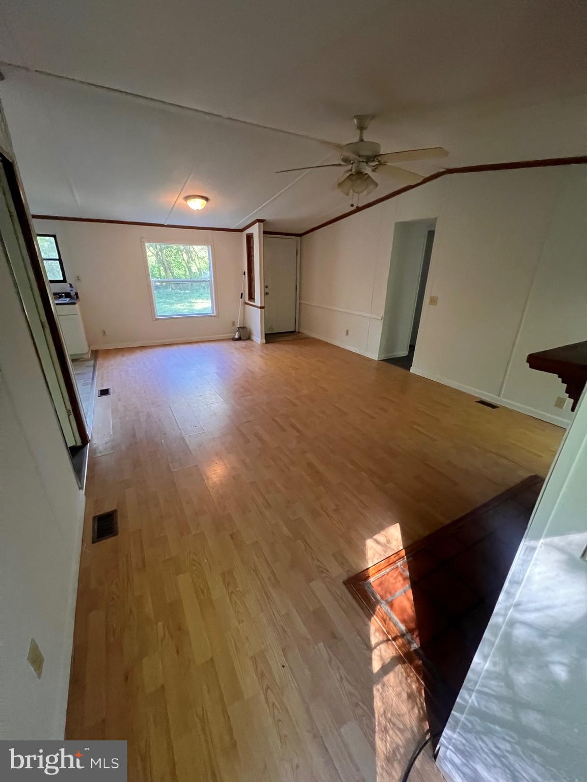 5215 Clark Canning House Road Hurlock, MD 21643 - Photo 3 of 10 a view of a big room with wooden floor and windows