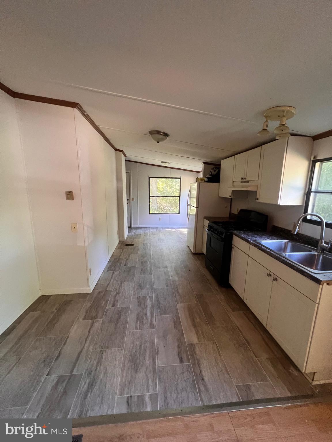 5215 Clark Canning House Road Hurlock, MD 21643 - Photo 4 of 10 a kitchen with granite countertop a stove and cabinets