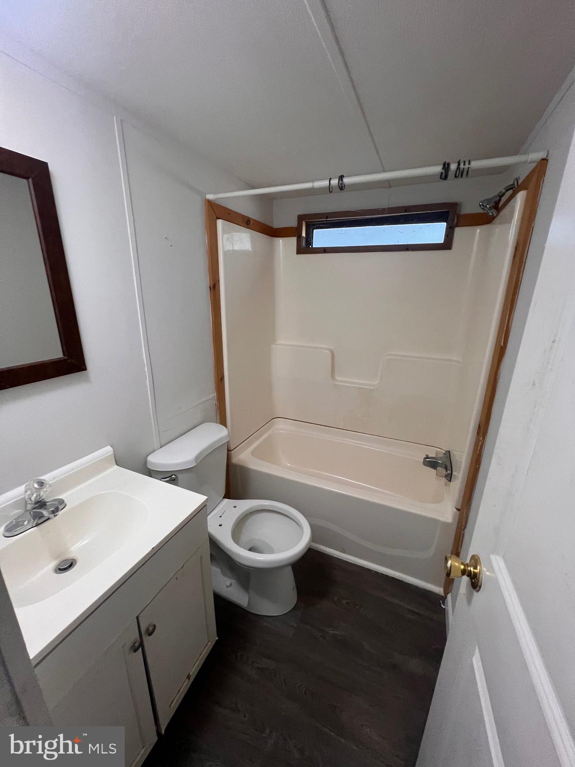 5215 Clark Canning House Road Hurlock, MD 21643 - Photo 6 of 10 a bathroom with a sink a toilet a mirror and shower