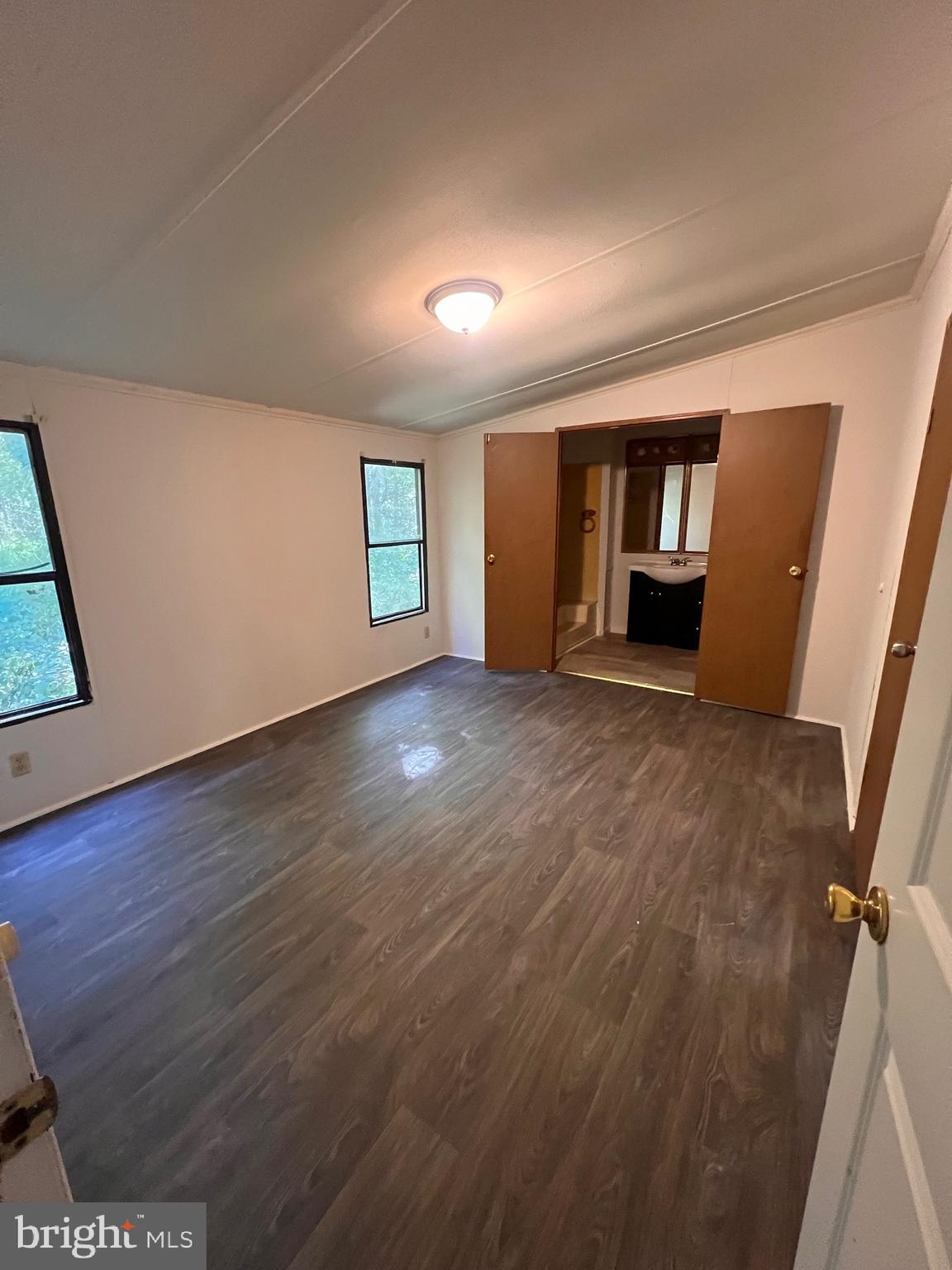5215 Clark Canning House Road Hurlock, MD 21643 - Photo 9 of 10 an empty room with wooden floor and window