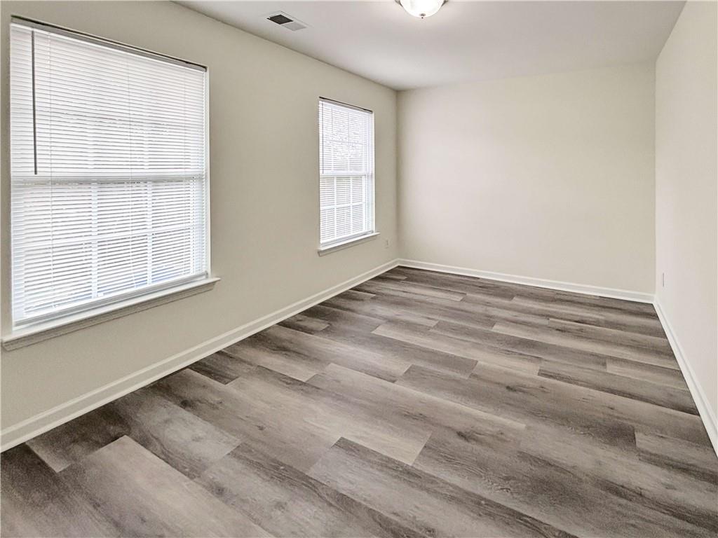 1400 Stonehaven Circle, Unit 1406 Cartersville, GA 30121 - Photo 14 of 21 an empty room with wooden floor and windows