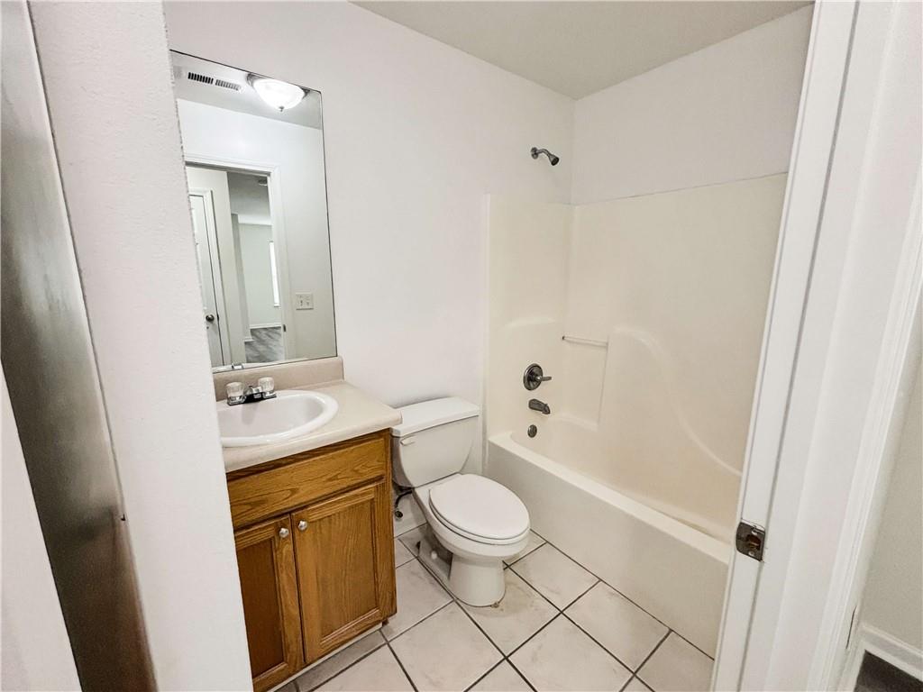1400 Stonehaven Circle, Unit 1406 Cartersville, GA 30121 - Photo 18 of 21 a bathroom with a granite countertop sink toilet and shower