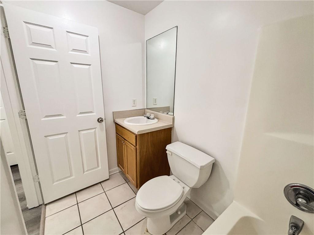 1400 Stonehaven Circle, Unit 1406 Cartersville, GA 30121 - Photo 19 of 21 a white toilet sitting next to a bathroom sink