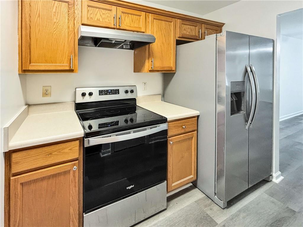 1400 Stonehaven Circle, Unit 1406 Cartersville, GA 30121 - Photo 8 of 21 a kitchen with a refrigerator and a stove