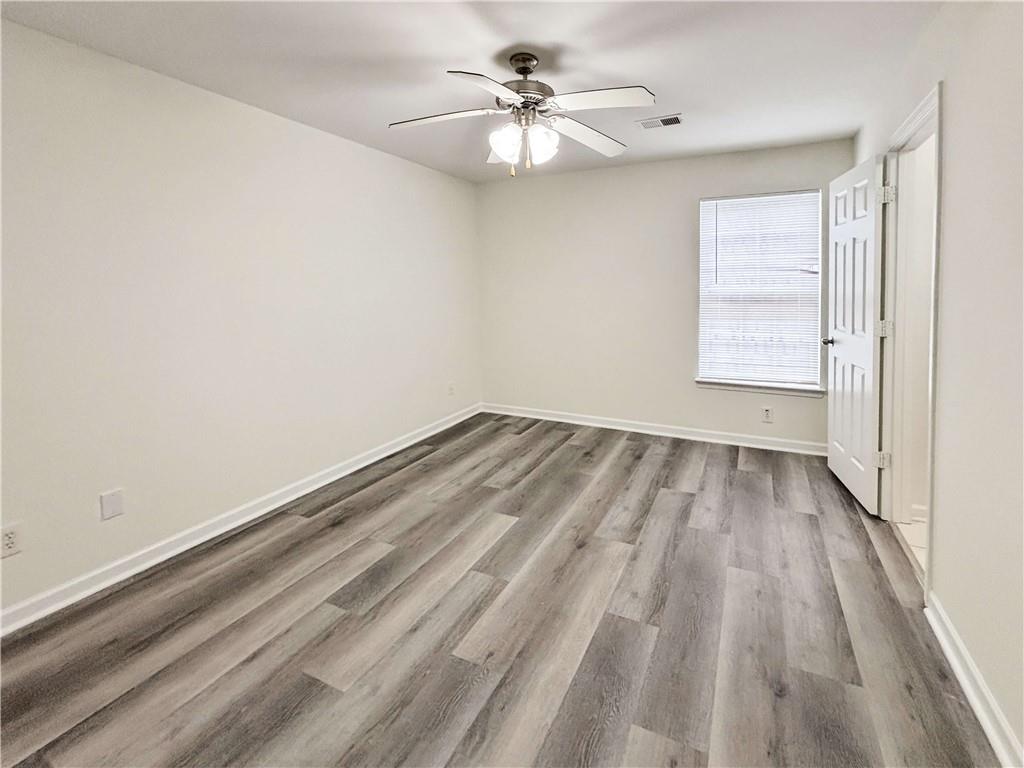 1400 Stonehaven Circle, Unit 1406 Cartersville, GA 30121 - Photo 9 of 21 wooden floor in an empty room with a window