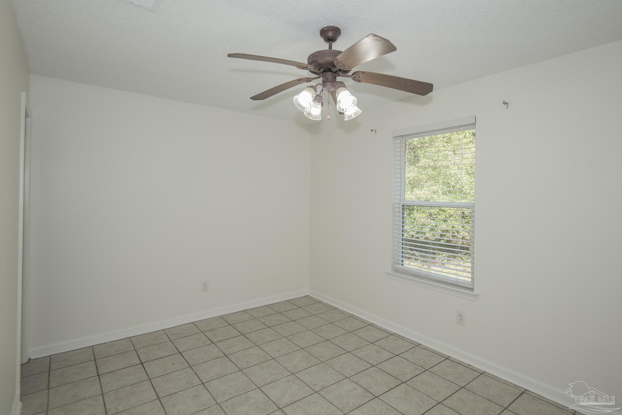 5578 Cyanamid Road Milton, FL 32583 - Photo 22 of 33 an empty room with windows and fan
