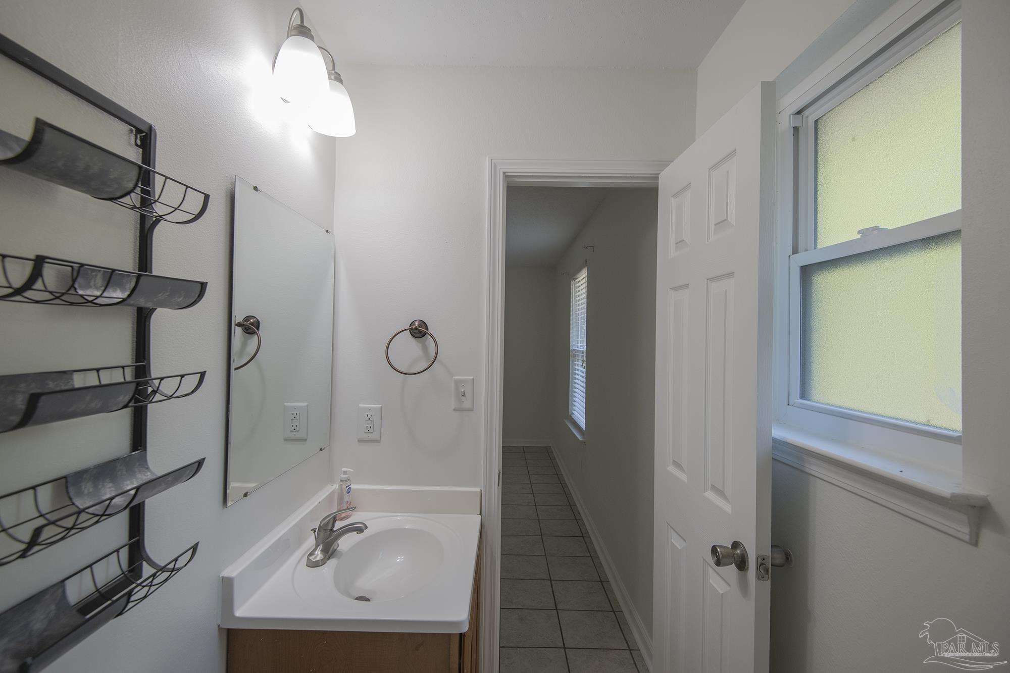5578 Cyanamid Road Milton, FL 32583 - Photo 25 of 33 a bathroom with a sink a mirror and a shower