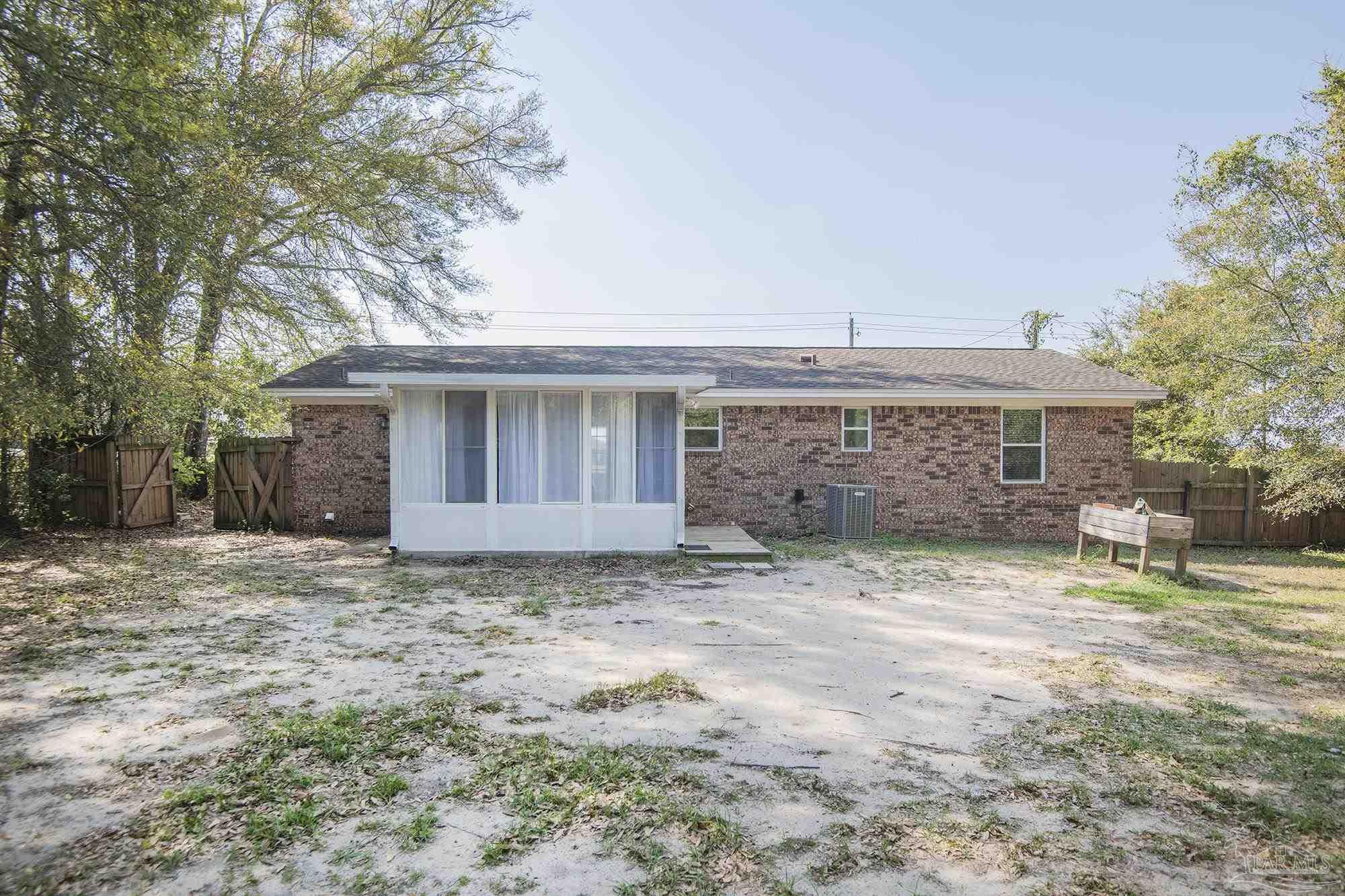 5578 Cyanamid Road Milton, FL 32583 - Photo 30 of 33 a view of a house with a large tree and wooden fence