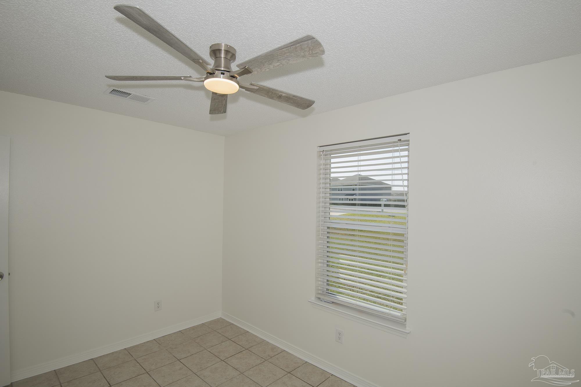 5578 Cyanamid Road Milton, FL 32583 - Photo 10 of 33 an empty room with windows and fan