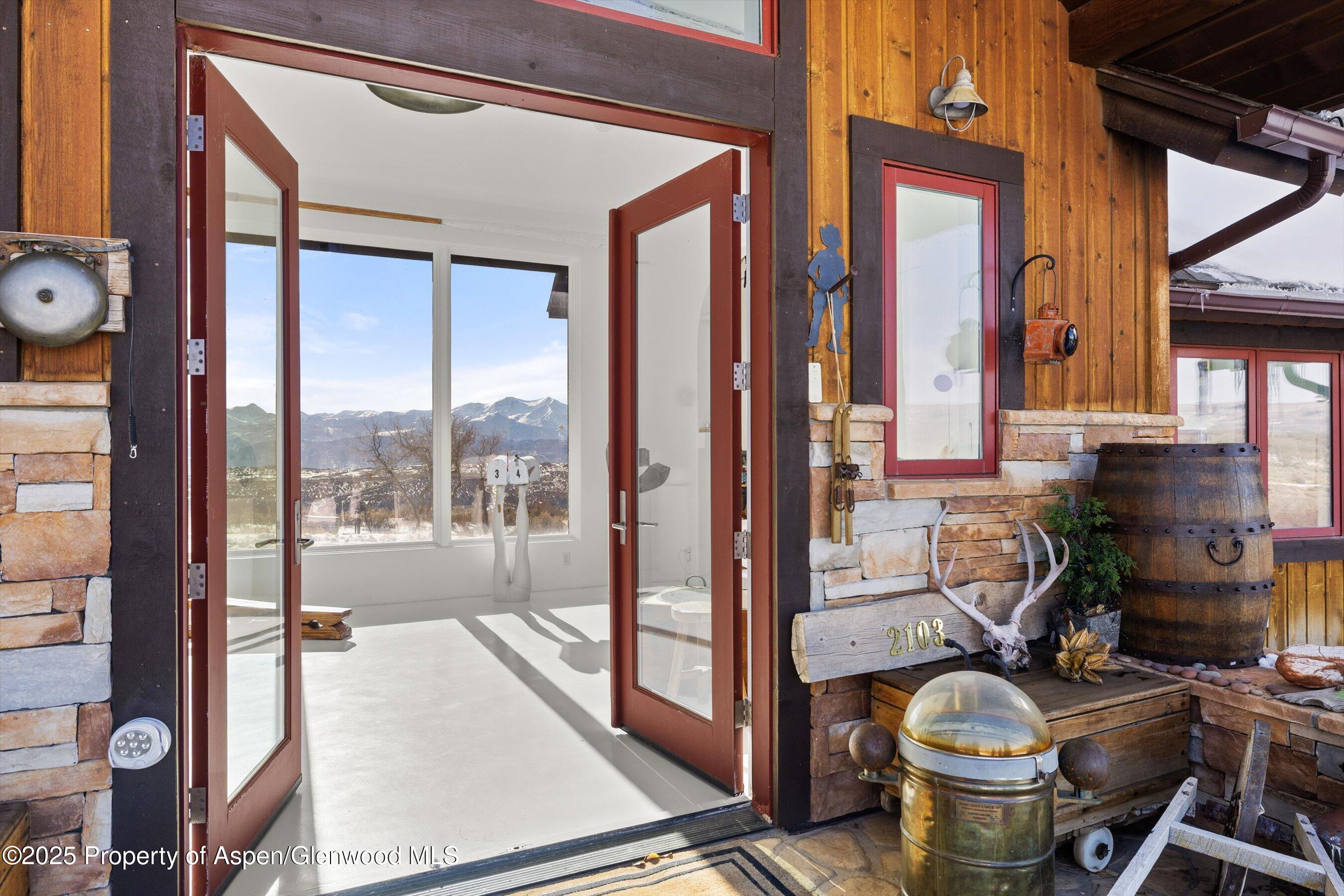 2103 Ten Peaks Mesa Road Carbondale, CO 81623 - Photo 37 of 52 a room with furniture a large window and wooden floor