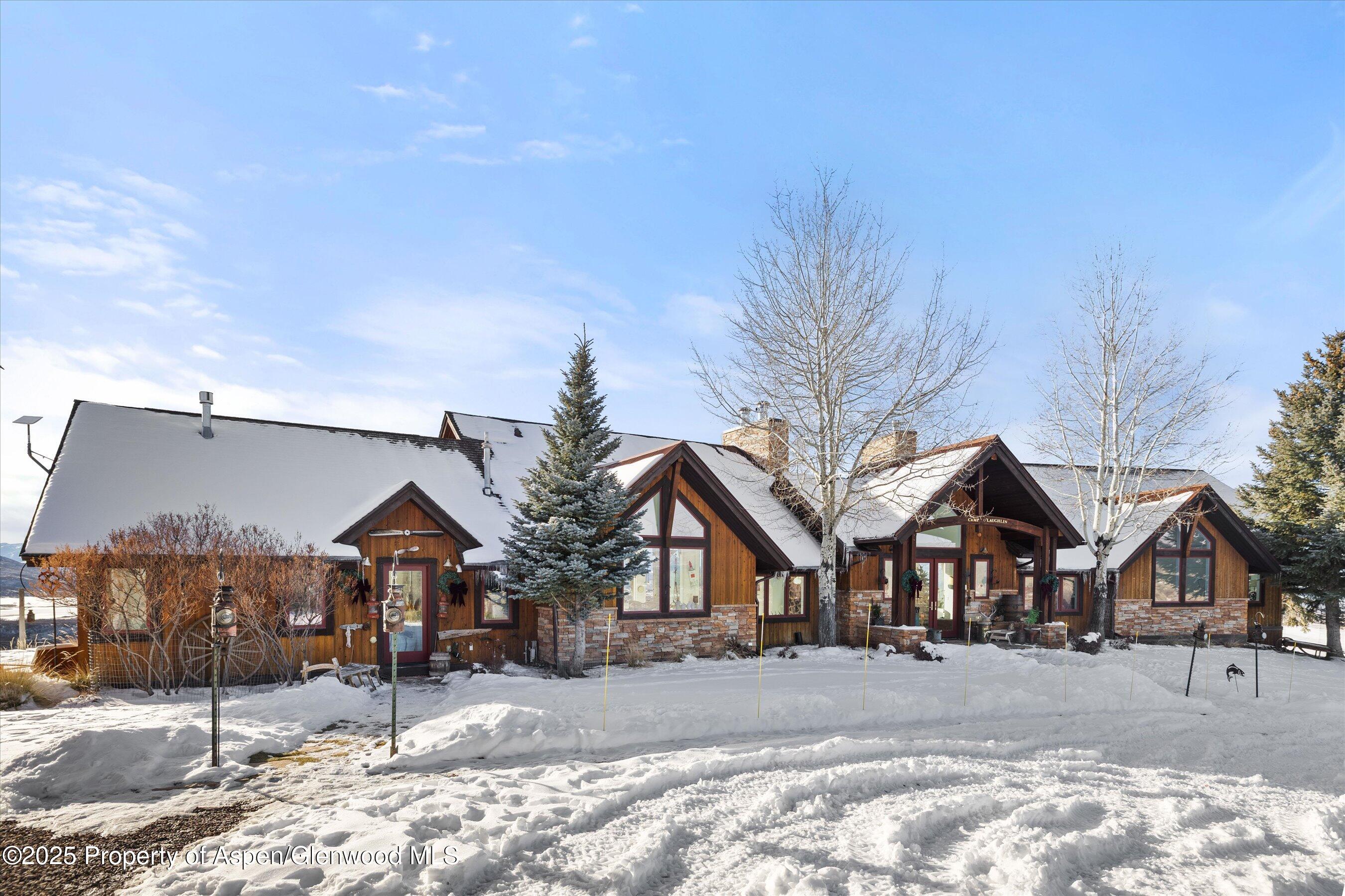 2103 Ten Peaks Mesa Road Carbondale, CO 81623 - Photo 41 of 52 a front view of a house with a yard covered in snow