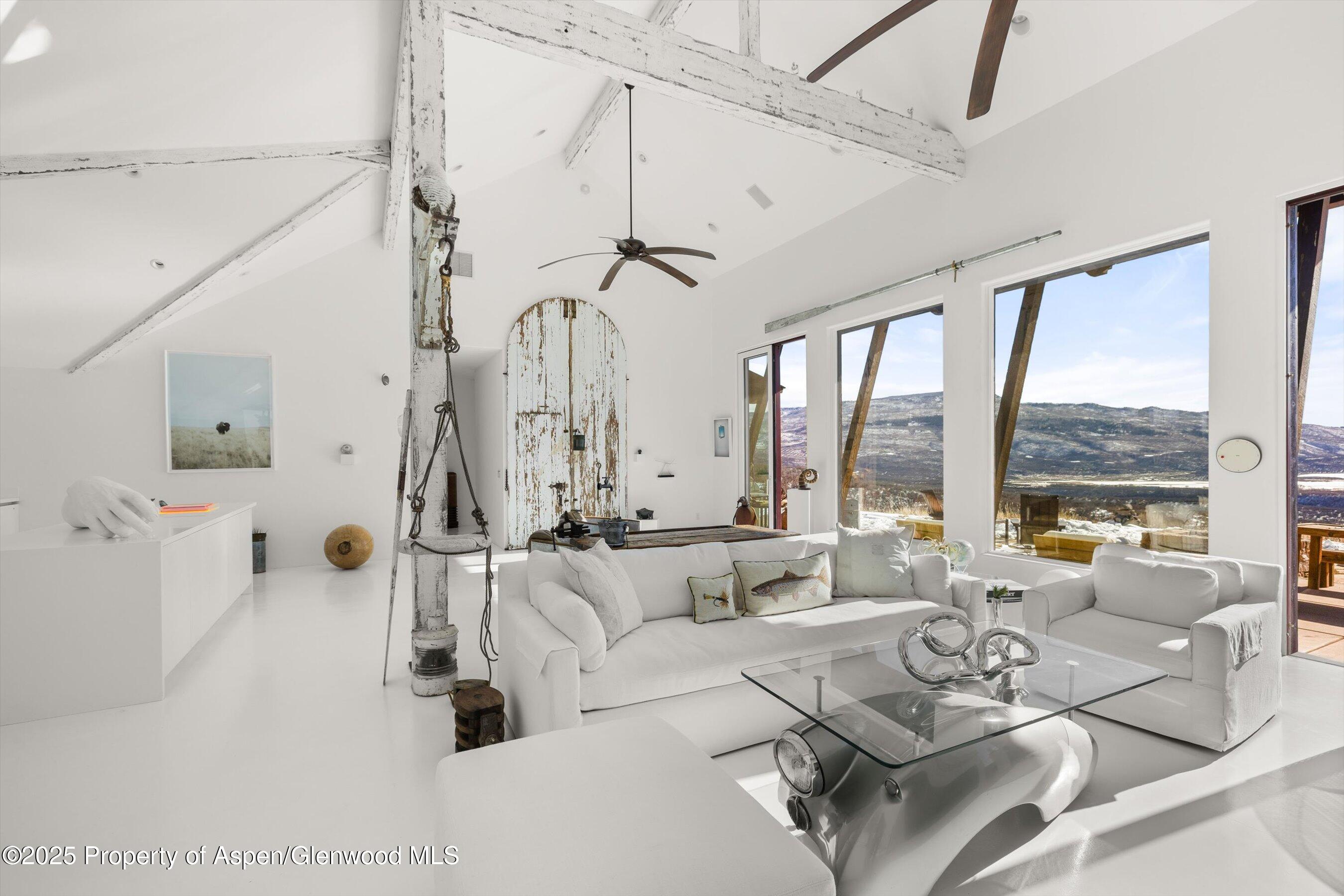 2103 Ten Peaks Mesa Road Carbondale, CO 81623 - Photo 7 of 52 a living room with furniture and a large window
