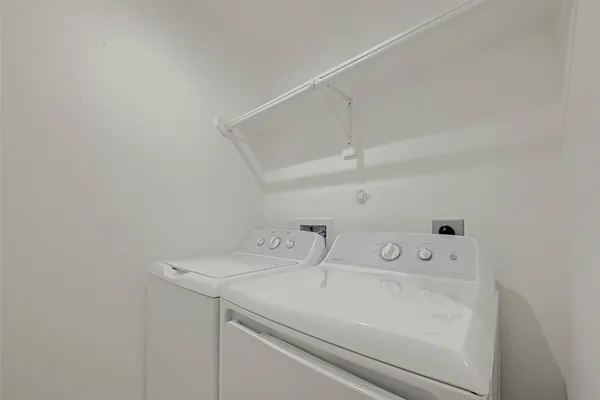 an empty room with a ceiling fan and window