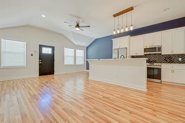 a view of a kitchen with microwave and cabinets