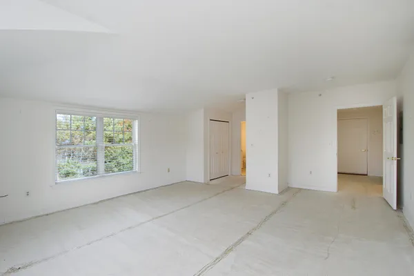 an empty room with a empty space and windows