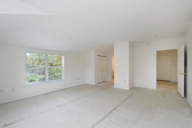 an empty room with a empty space and windows