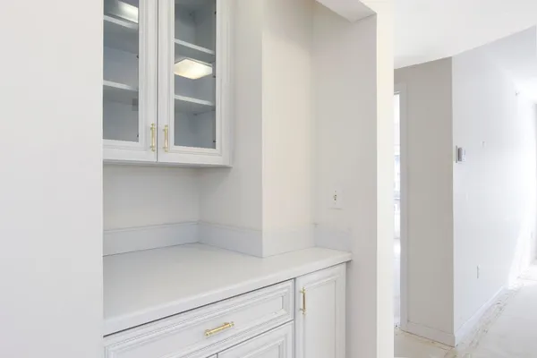a bathroom with a granite countertop sink a toilet and a mirror
