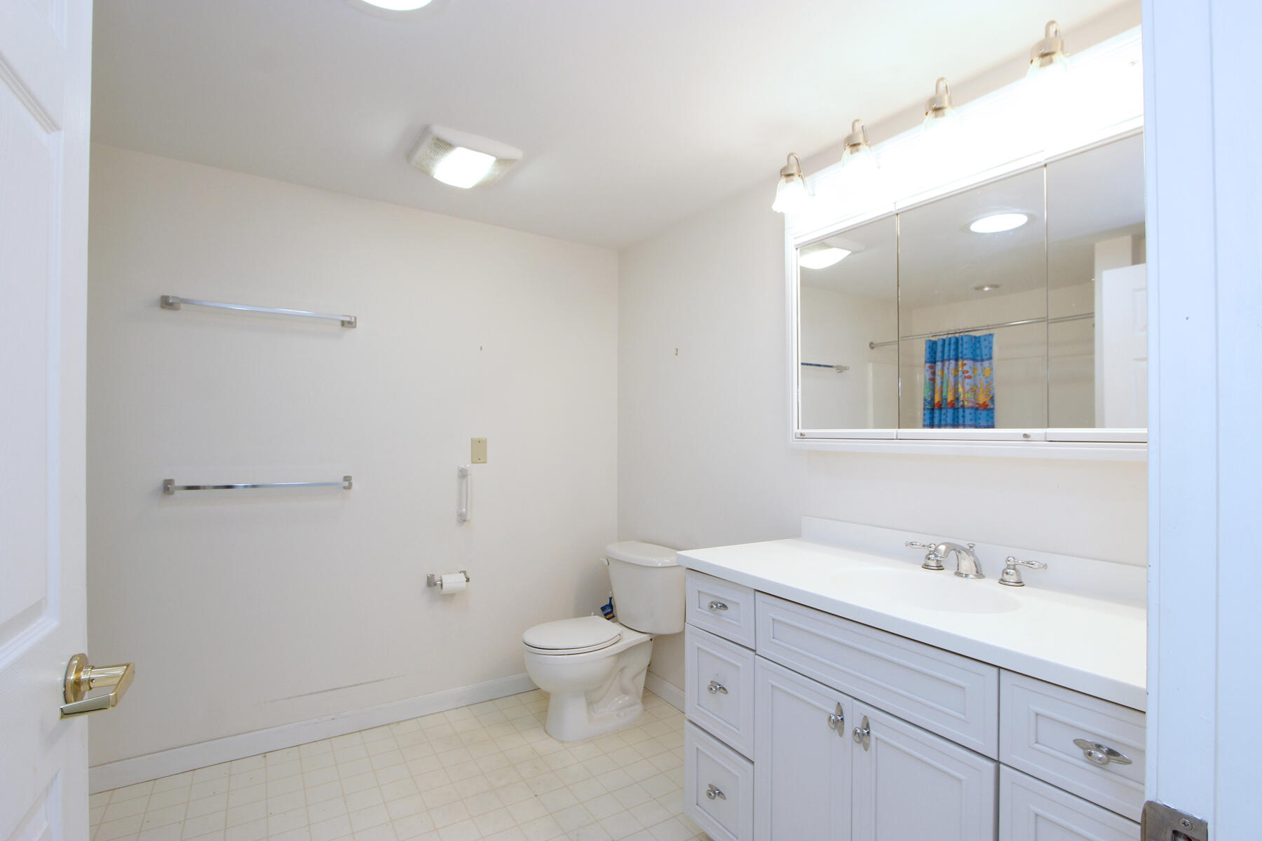 18 West Road, Unit 307 Orleans, MA 02653 - Photo 17 of 31 a bathroom with a granite countertop sink a toilet and a mirror