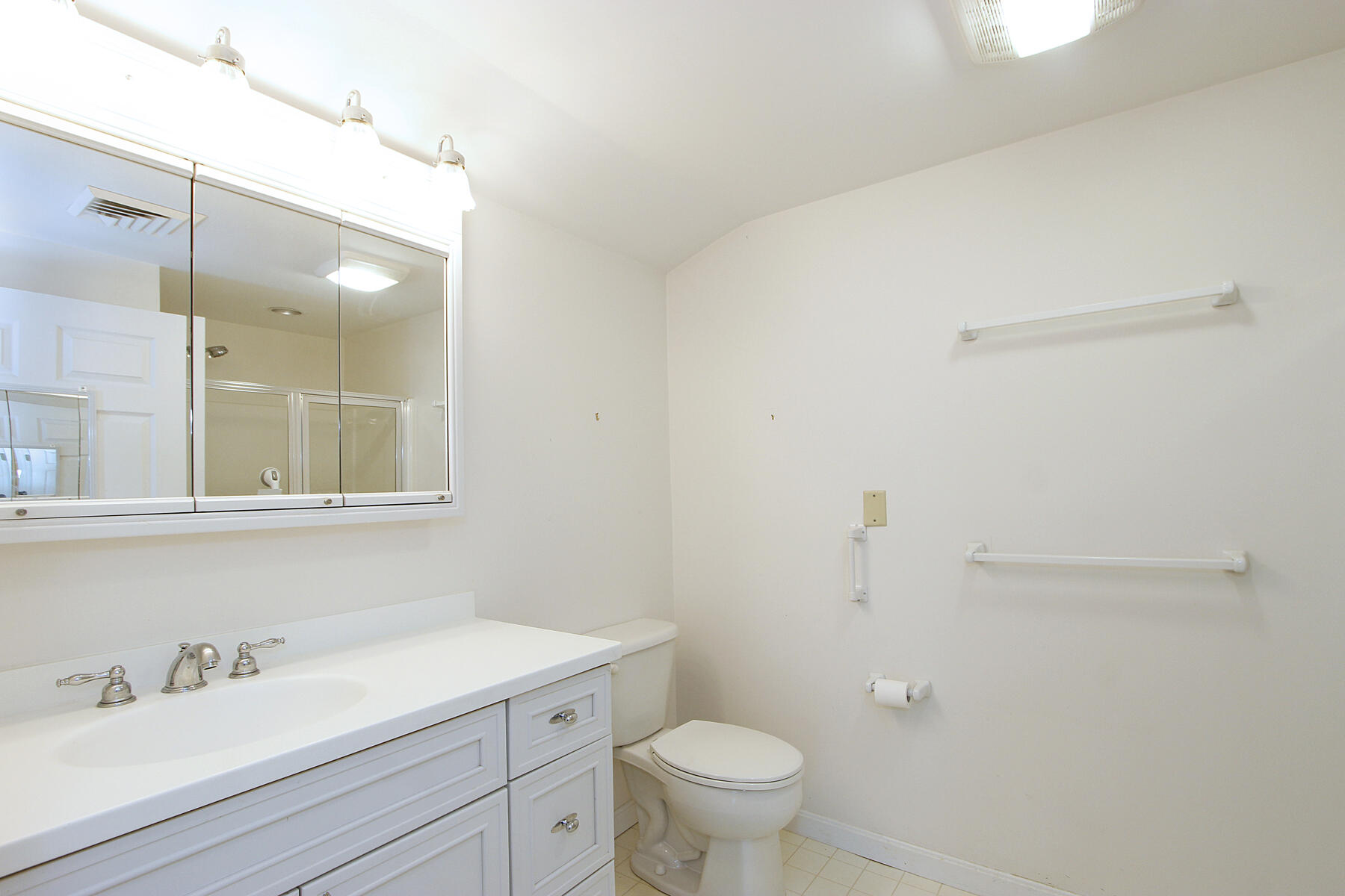 18 West Road, Unit 307 Orleans, MA 02653 - Photo 19 of 35 a bathroom with a sink a toilet and a mirror