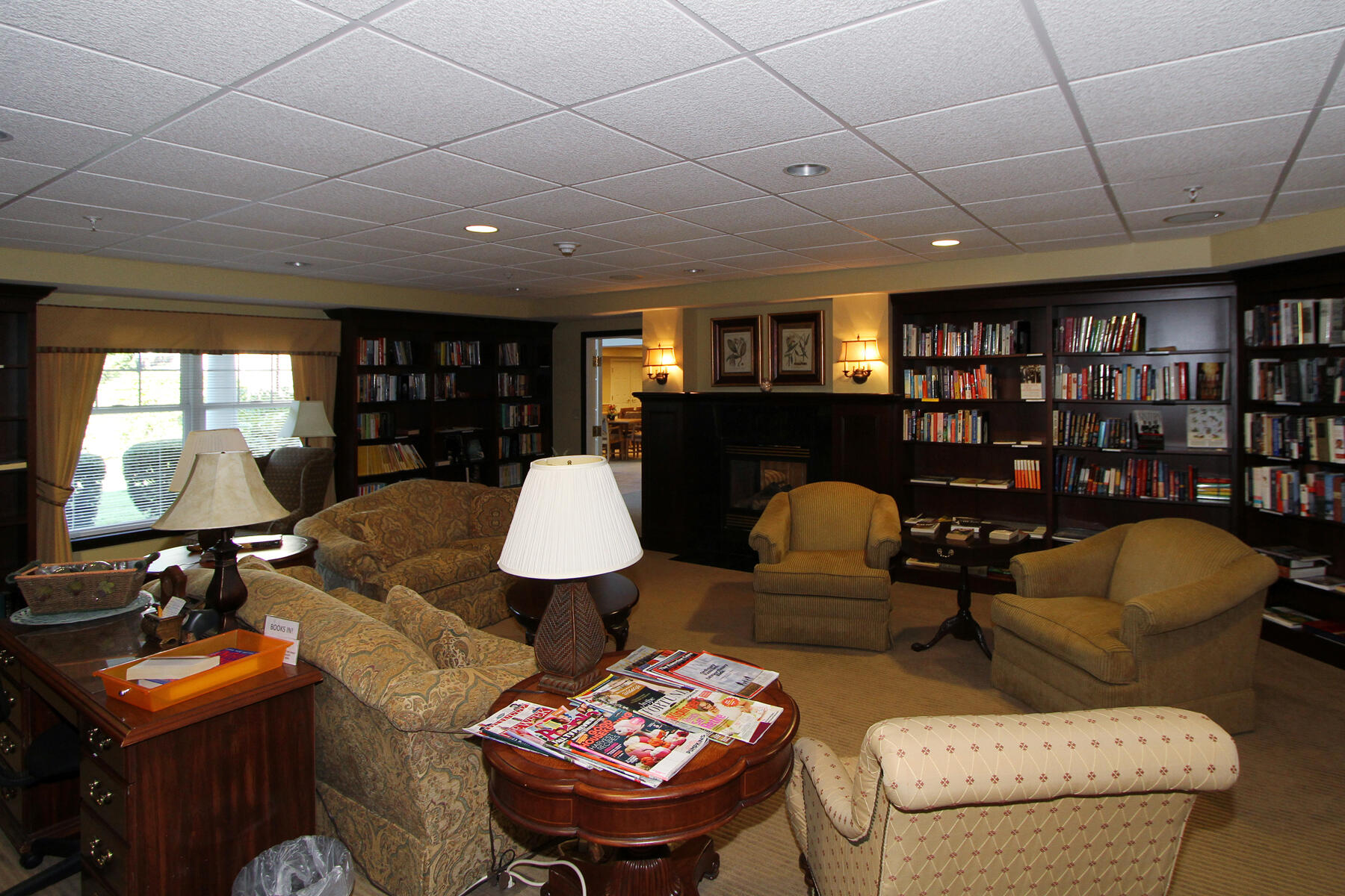 18 West Road, Unit 307 Orleans, MA 02653 - Photo 26 of 31 a living room with furniture a rug and a bookshelf