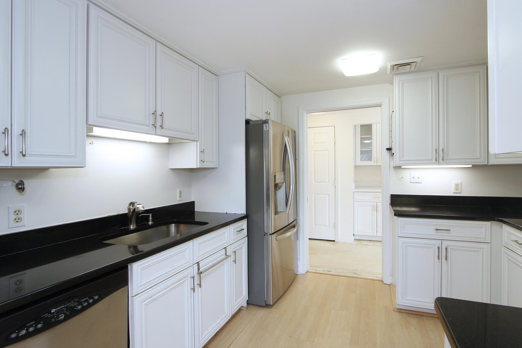 18 West Road, Unit 307 Orleans, MA 02653 - Photo 5 of 31 a kitchen with granite countertop white cabinets and stainless steel appliances