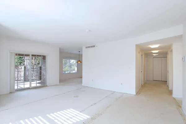 an empty room with windows and closet