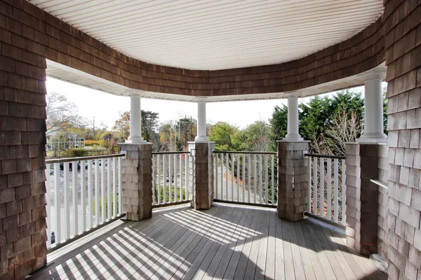 a view of a porch with wooden floor