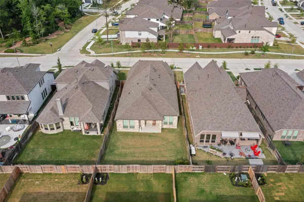 an aerial view of a house with a yard