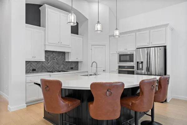 a kitchen with a stove a sink and a refrigerator