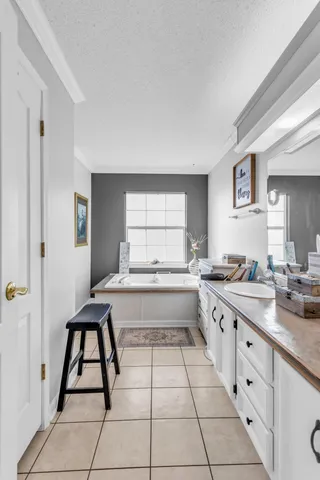 a large white kitchen with a stove a sink dishwasher and a refrigerator