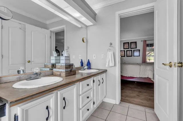 a en suite bathroom with a granite countertop sink and a mirror