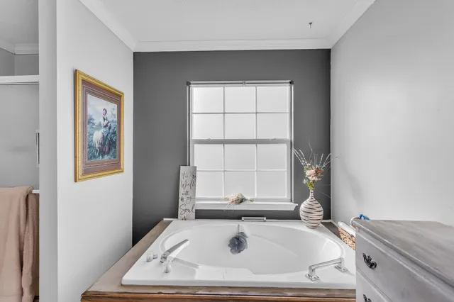 a bath tub sitting in a bathroom next to a window