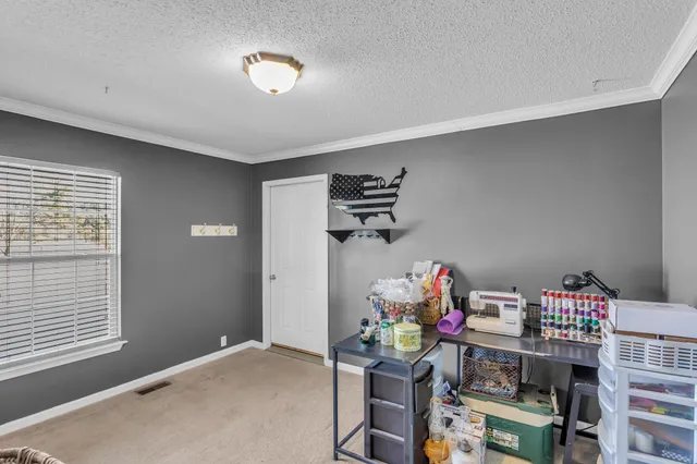 a bedroom with furniture and a window