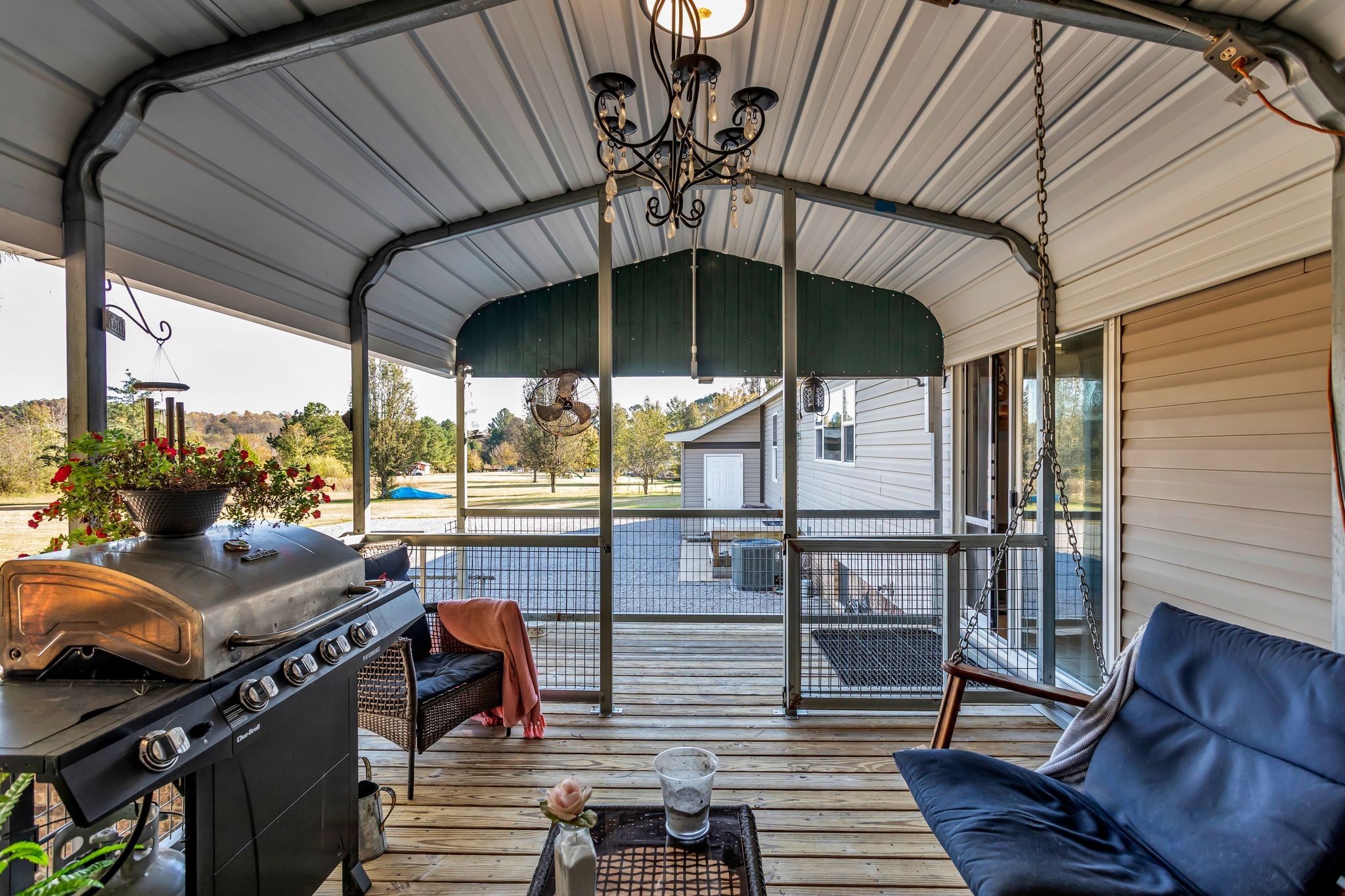 2673 McKnight Road Culleoka, TN 38451 - Photo 33 of 41 a view of a patio with table and chairs potted plants with wooden floor