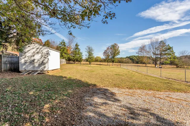 a swimming pool with outdoor seating and yard