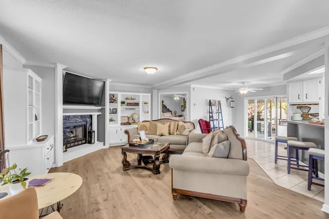 a living room with furniture a fireplace and a flat screen tv