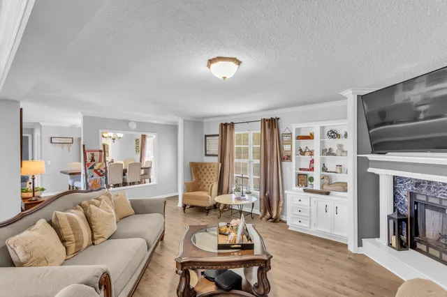 a living room with furniture flat screen tv and a fireplace
