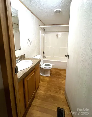 a bathroom with a sink a mirror and a shower