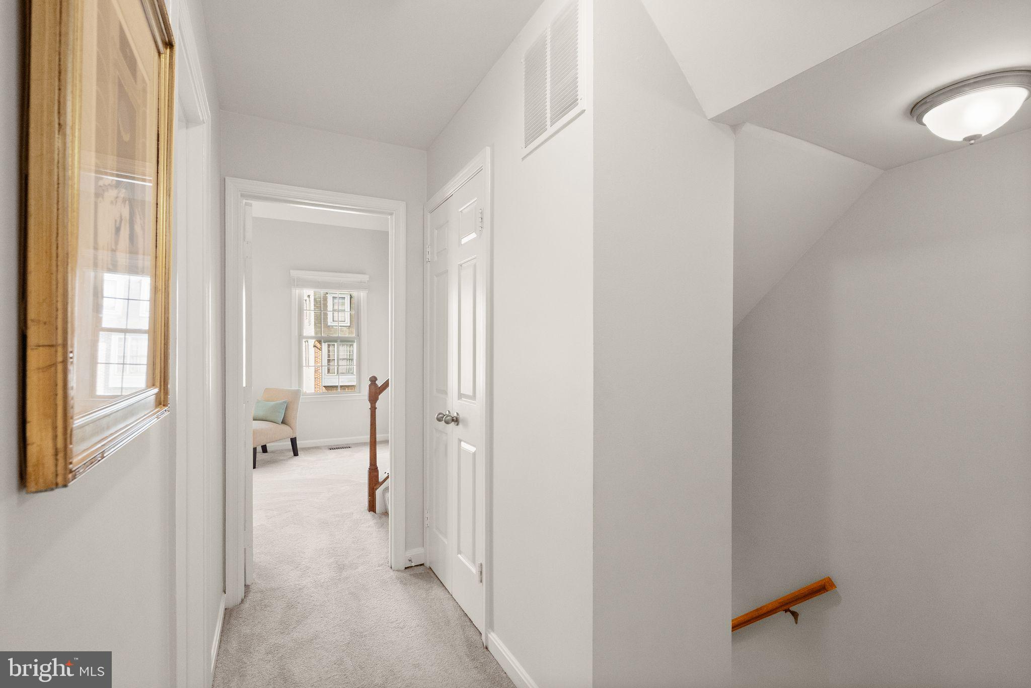 6369 English Ivy Way Springfield, VA 22152 - Photo 50 of 62 a view of a hallway with wooden floor and a bathroom