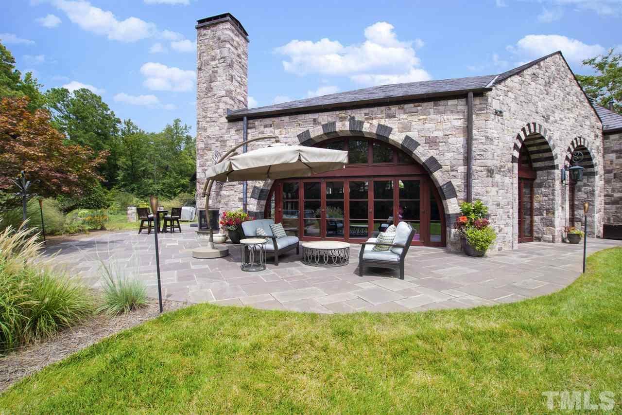 483 Rosemont Drive Durham, NC 27713 - Photo 25 of 88 a view of a patio with a table and chairs under an umbrella with a patio