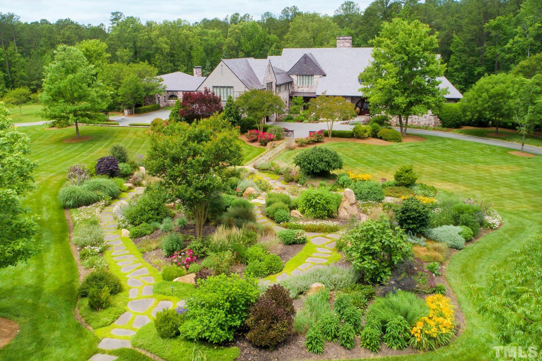 483 Rosemont Drive Durham, NC 27713 - Photo 36 of 88 a view of a garden with a building in the background