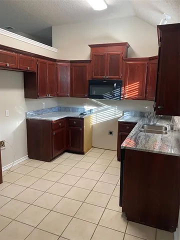 a kitchen with stainless steel appliances granite countertop a sink counter space and cabinets