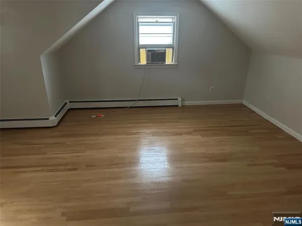a view of a room with wooden floor and window