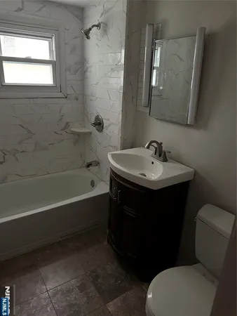 a bathroom with a sink toilet and bathtub